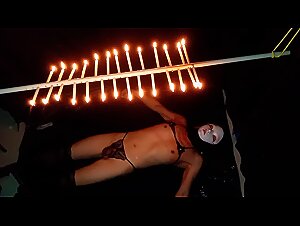 Drip candle wax on your body with the plug inserted into your anus